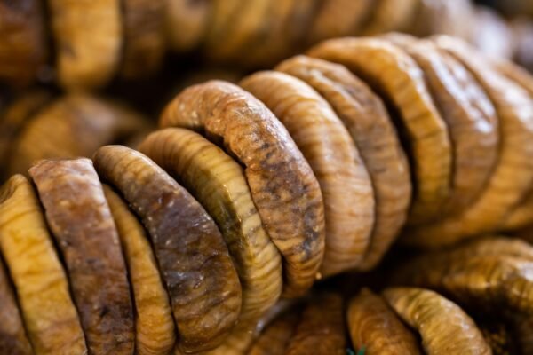 A detailed close-up image of stacked dried figs showcasing texture and color.
